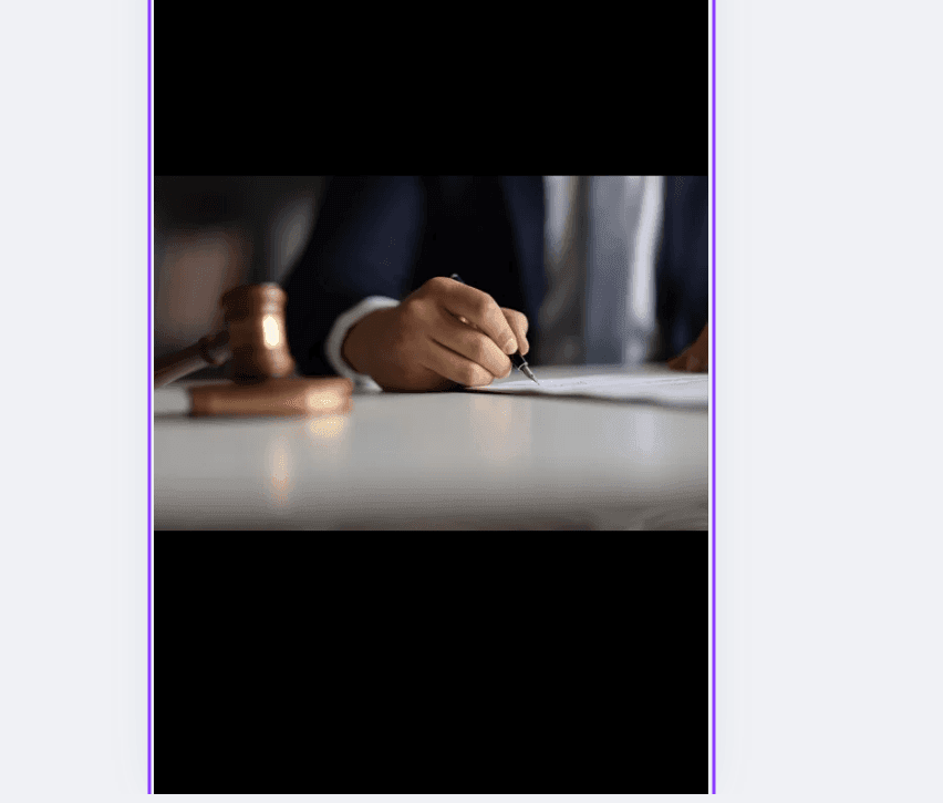 Person in suit signing a document with a pen, gavel blurred in foreground.